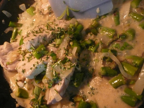 The pork asparagus mixture bubbling in the pan