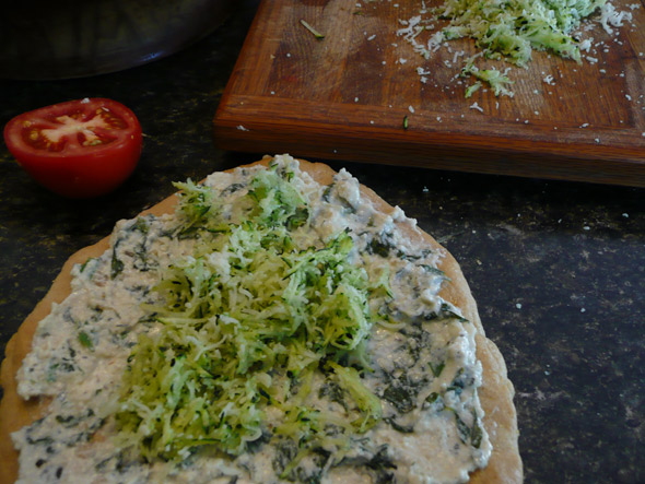 Adding the zucchini cheese mixture to the Pizza