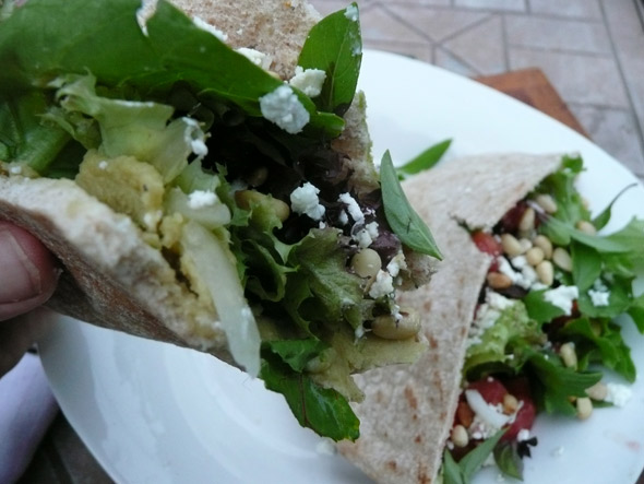 Pita with hummus and lovely salad stuffings Pita with hummus, mixed greens, goat cheese, feta, tomato & toasted pinons