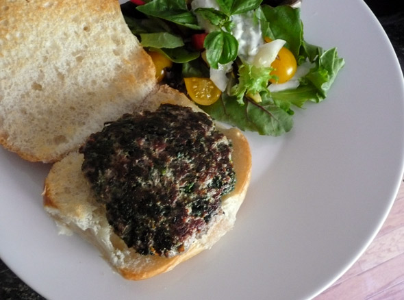 Feta-stuffed Gryo Burger on a bun, ready for topping ...