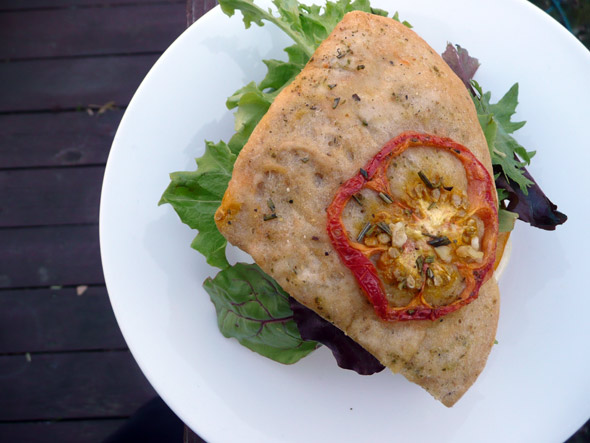 Top with greens and the top half of the toasted focaccia