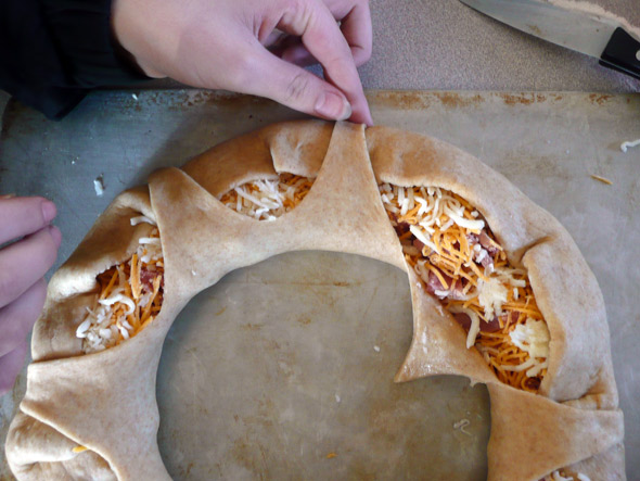 Ham and Cheese Stuffed Bread Wreath: fold over the edges of the dough over the filling