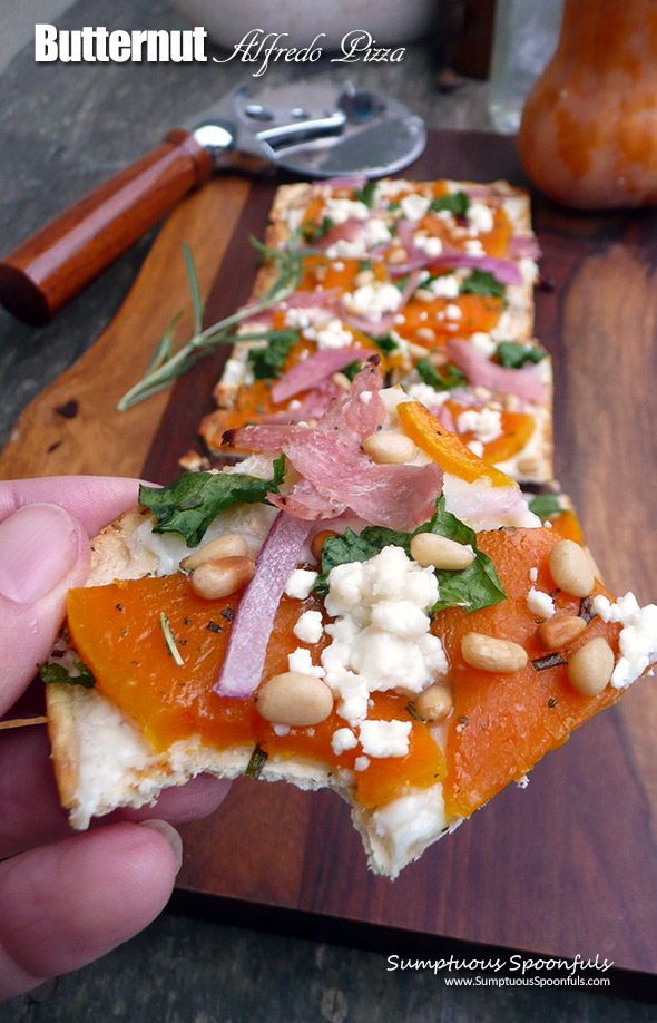 Butternut Alfredo Pizza ~ you will totally fall in love with this sweet & savory pizza! Thin sliced butternut squash roasted with garlic & herbs, with prosciutto, red onion, pine nuts, crumbled goat cheese and a bit of kale
