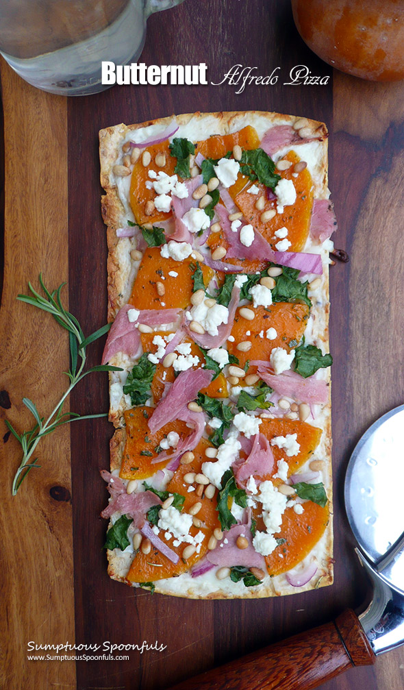 Butternut Alfredo Pizza ~ you will totally fall in love with this sweet & savory pizza! Thin sliced butternut squash roasted with garlic & herbs, with prosciutto, red onion, pine nuts, crumbled goat cheese and a bit of kale