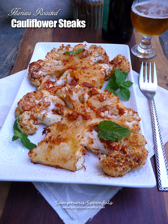 Harissa Roasted Cauliflower Steaks with warm garlic chickpea salad and mediterranean "steak sauce"