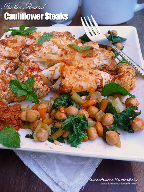 Harissa Roasted Cauliflower Steaks with warm garlic chickpea salad and mediterranean "steak sauce"