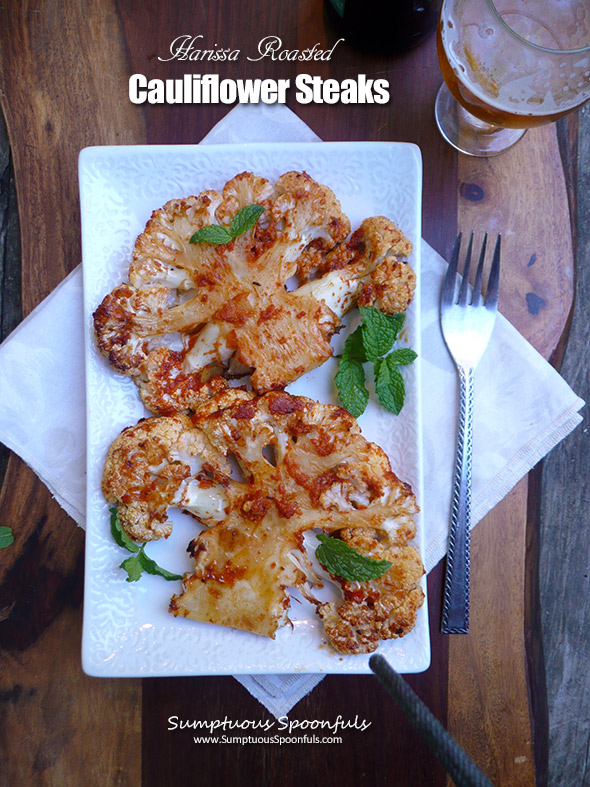 Harissa Roasted Cauliflower Steaks with warm garlic chickpea salad and mediterranean "steak sauce"