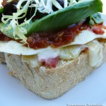Bacon, Egg & Tomato Tapenade Sandwich with White Cheddar & Mixed Greens